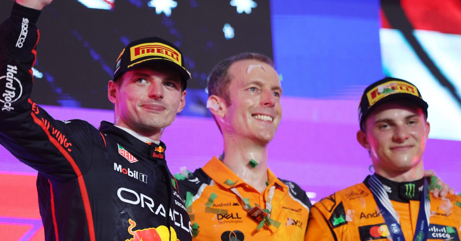 JEDDAH, SAUDI ARABIA - APRIL 20: Second placed Max Verstappen of the Netherlands and Oracle Red Bull Racing waves from the podium alongside the McLaren trophy delegate and Race winner Oscar Piastri of Australia and McLaren during the F1 Grand Prix of Saudi Arabia at Jeddah Corniche Circuit on April 20, 2025 in Jeddah, Saudi Arabia. (Photo by Meg Oliphant/Getty Images) // Getty Images / Red Bull Content Pool // SI202504200315 // Usage for editorial use only //