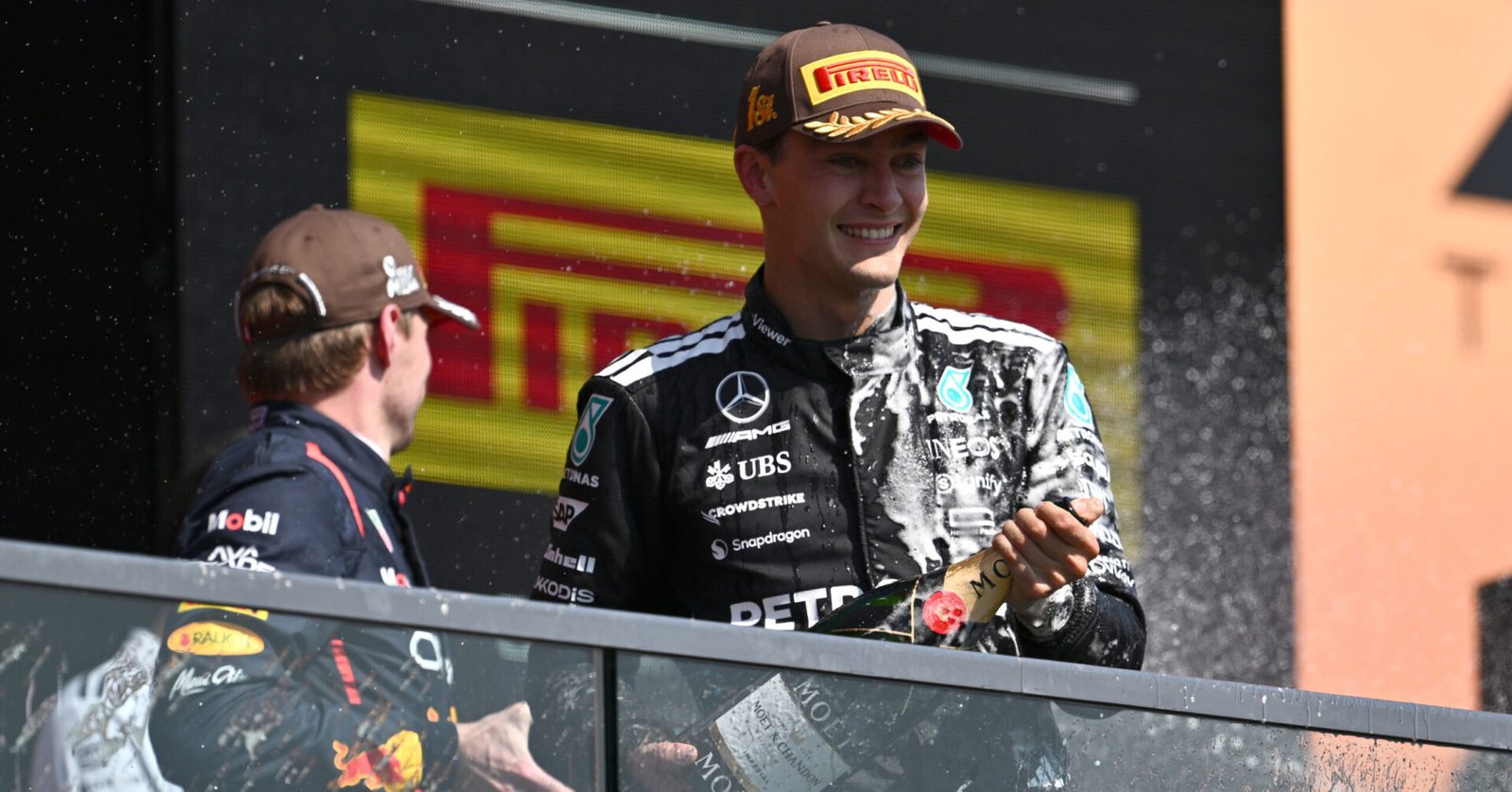 MONTREAL, QUEBEC - JUNE 15: Second placed Max Verstappen of the Netherlands and Oracle Red Bull Racing and Race winner George Russell of Great Britain and Mercedes AMG Petronas F1 Team celebrate on the podium during the F1 Grand Prix of Canada at Circuit Gilles-Villeneuve on June 15, 2025 in Montreal, Quebec. (Photo by Minas Panagiotakis/Getty Images) // Getty Images / Red Bull Content Pool // SI202506150801 // Usage for editorial use only //