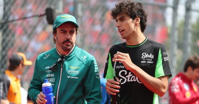 BUDAPEST, HUNGARY - AUGUST 03: Fernando Alonso of Spain and Aston Martin F1 Team and Gabriel Bortoleto of Brazil and Stake F1 Team Kick Sauber talk on the drivers parade prior to the F1 Grand Prix of Hungary at Hungaroring on August 03, 2025 in Budapest, Hungary.