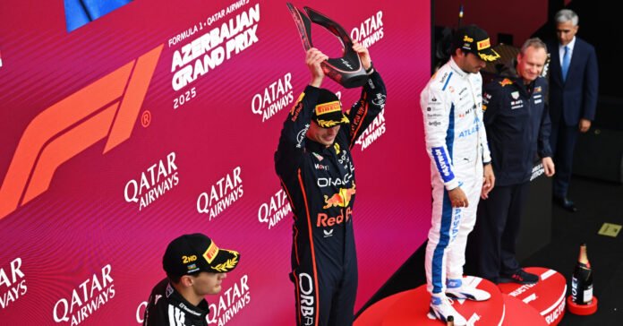 BAKU, AZERBAIJAN - SEPTEMBER 21: Race winner Max Verstappen of the Netherlands and Oracle Red Bull Racing lifts the winners trophy on the podium during the F1 Grand Prix of Azerbaijan at Baku City Circuit on September 21, 2025 in Baku, Azerbaijan. (Photo by Sam Bagnall/Sutton Images) // Getty Images / Red Bull Content Pool // SI202509210500 // Usage for editorial use only //